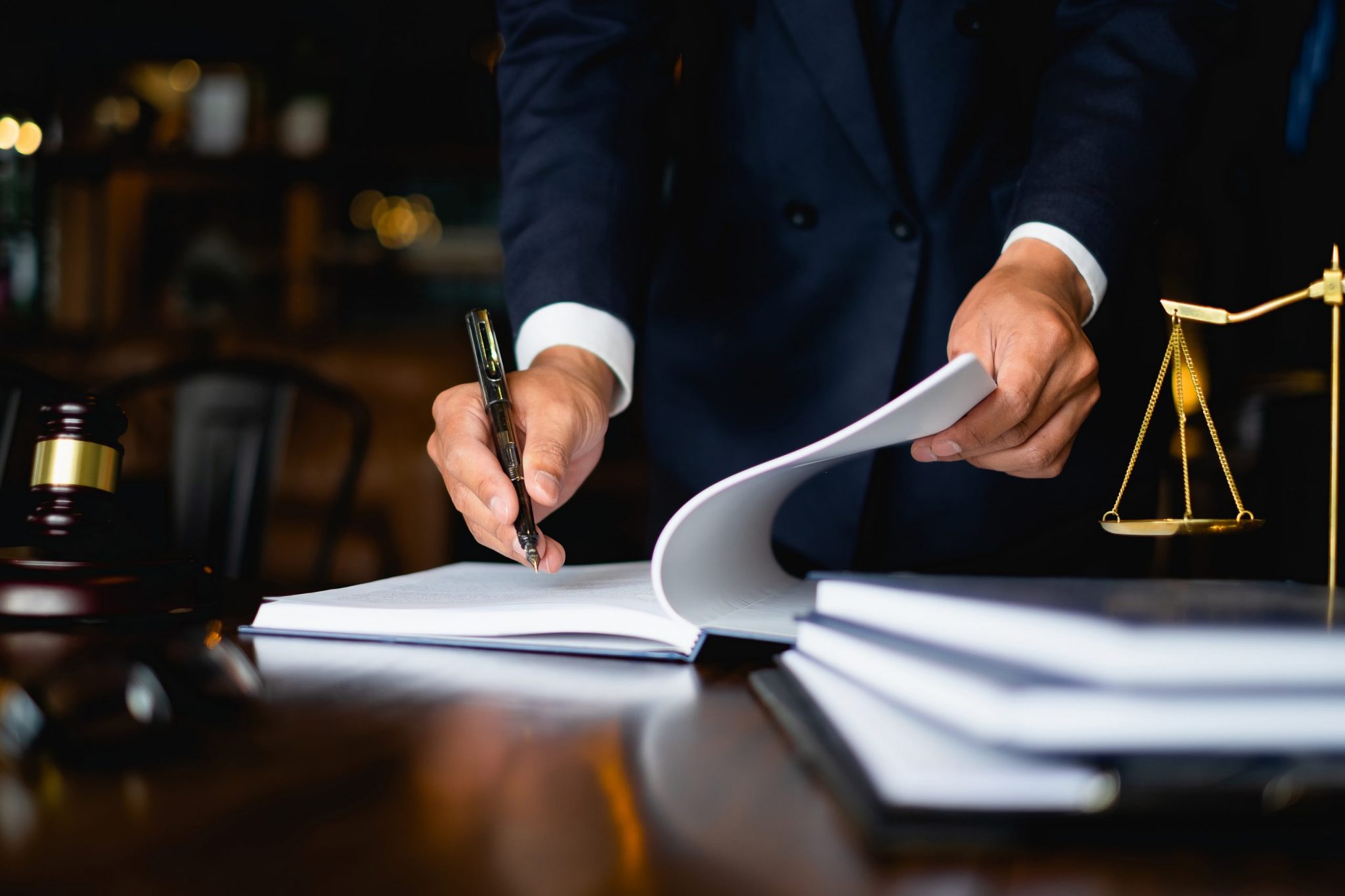 Close up lawyer businessman working or reading lawbook in office workplace for consultant lawyer concept. Close up lawyer businessman working or reading lawbook in office workplace for consultant lawyer concept.