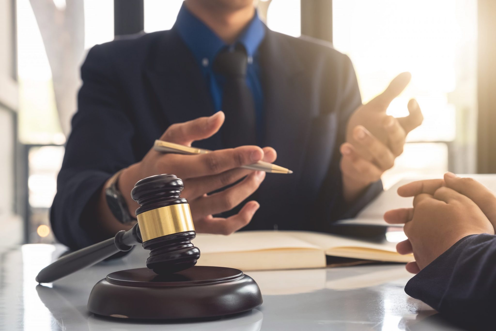 Business lawyer working about legal legislation in courtroom to help their customer Business lawyer working about legal legislation in courtroom to help their customer