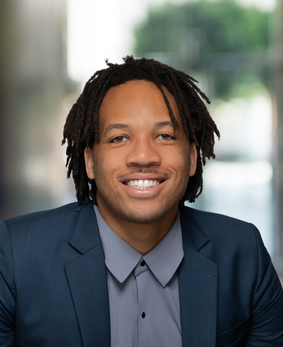 72081b75-780a-43ff-a55f-194d1e398964 personal injury attorney jaric erike smiling at the camera in a blue business suit