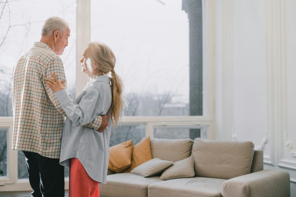 Older couple dancing in living room