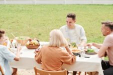 Family gathered at a table outside for a meal